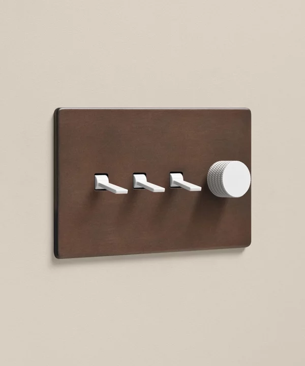 bronze combination switch featuring three toggles and one dimmer