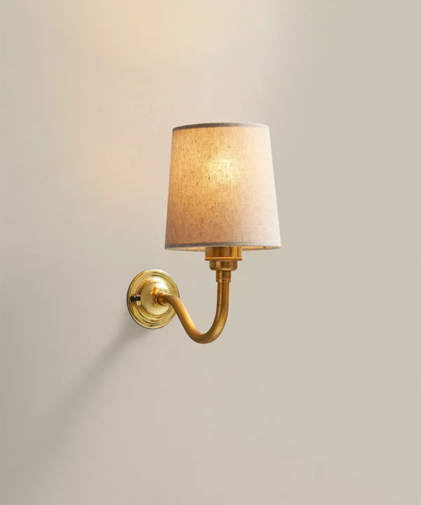 linen shade on a gold traditional wall sconce
