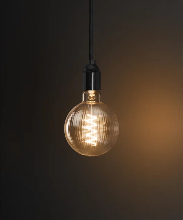 warm white LED light bulb with ribbed surface texture