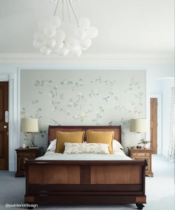 Large frosted bubble chandelier light above a bed with linen cables