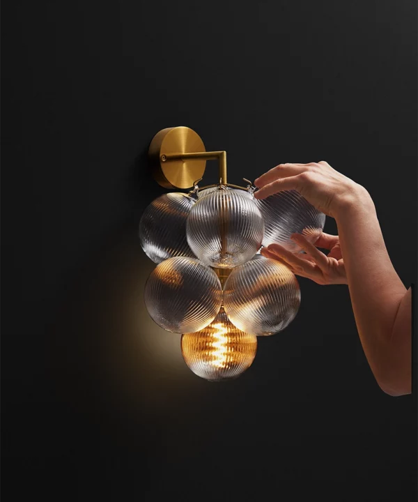 bubble wall light with gold metal hardware and ribbed baubles