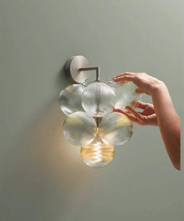 glass wall light with fluted baubles and silver wall mount