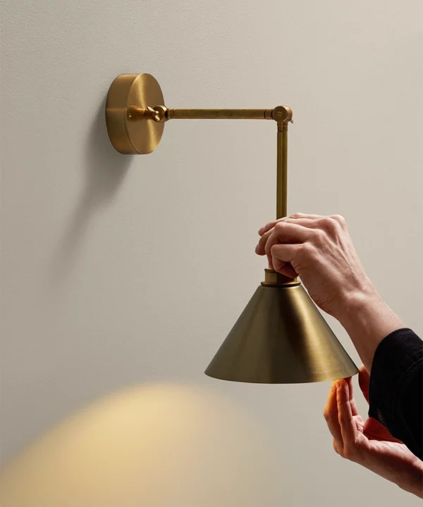 gold adjustable wall light with gold metal shade