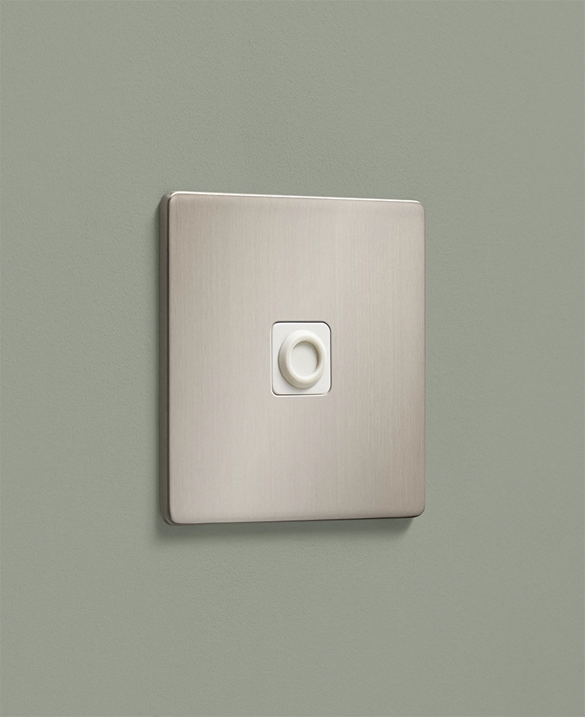 brushed silver dull nickel flex outlet on a pale sage painted wall