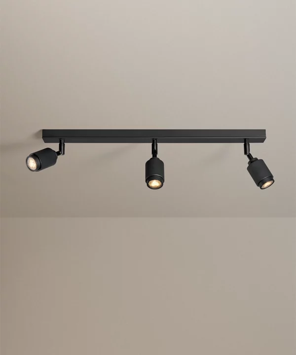 modern ceiling spotlights in black with three lights shot on a grey neutral background