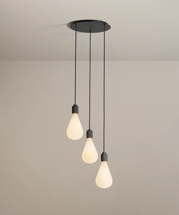 A black 3-point ceiling light with three pendants hanging at various lengths from one ceiling rose