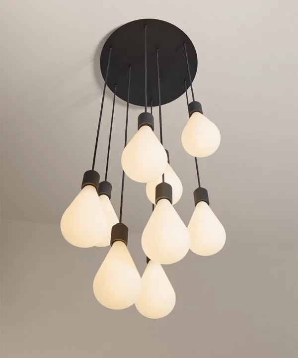 cascading designer ceiling light with nine opaque teardrop bulbs, black hardware and black linen cable