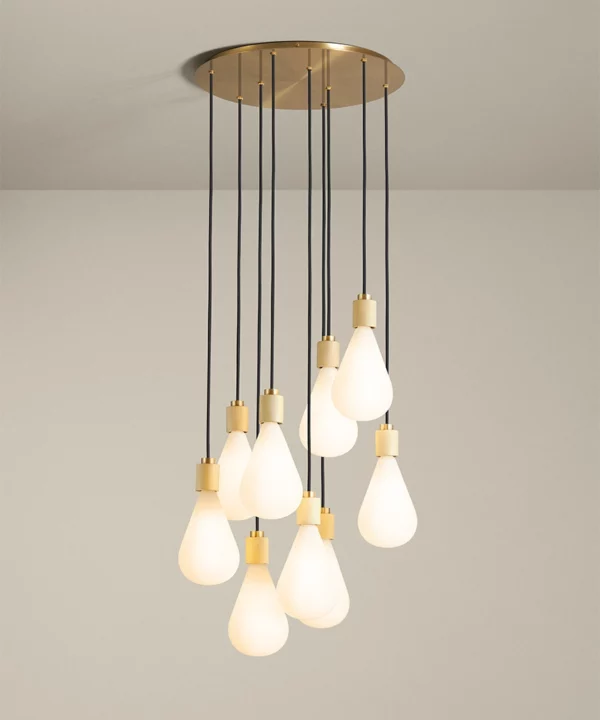 nine light cascading pendant in gold with teardrop opaque light bulbs