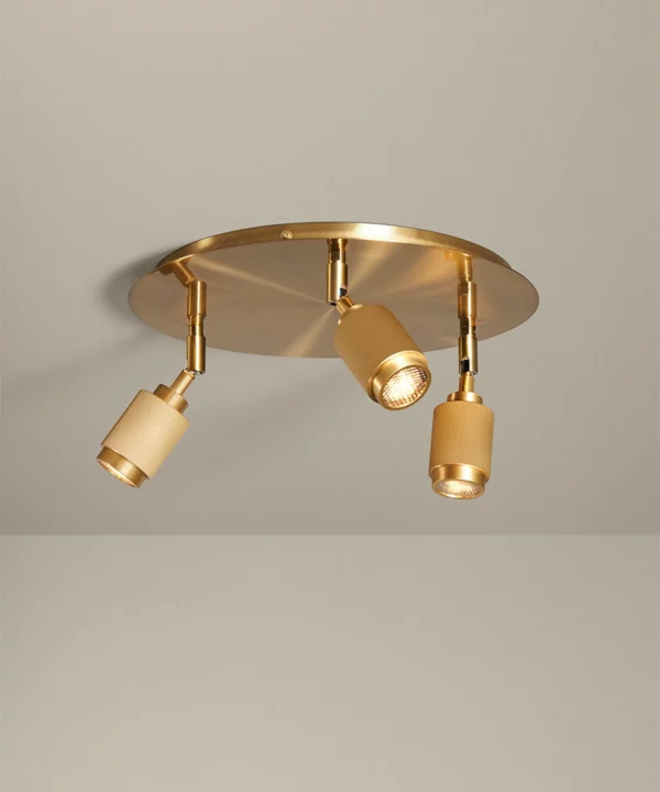 three ribbed gold adjustable spotlights on a large gold ceiling rose