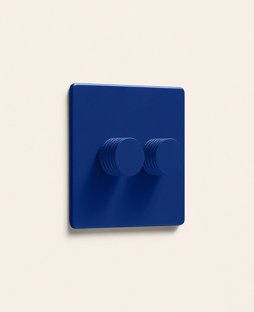 Cobalt colourful double dimmer light switch on a pale neutral background