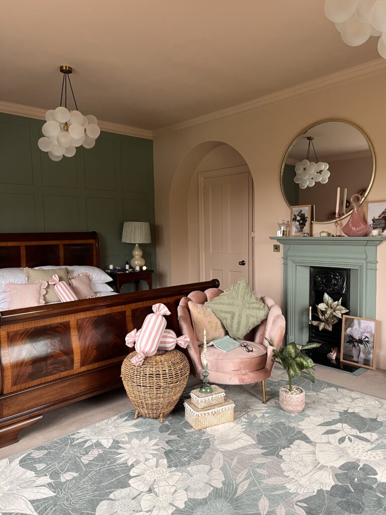 calm bedroom styled in shell pink and sage green with a bubble chandelier