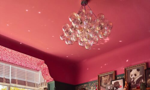 iridescent bubble chandelier in a magically eclectic maximalist pink and teal living room