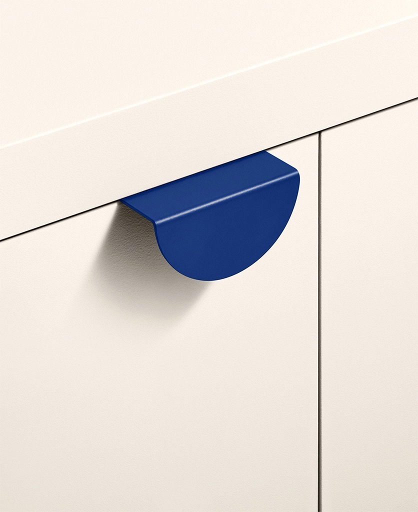 cobalt metal handle on a cream kitchen unit