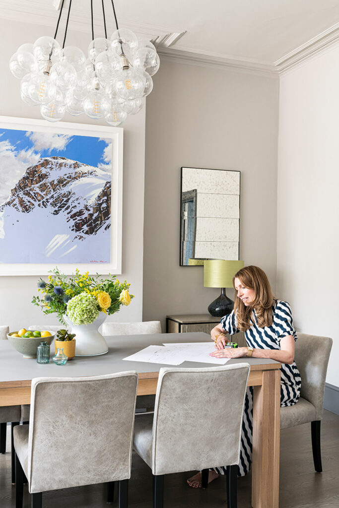 Emma Green Interior Designer sitting under a clear bubble chandelier